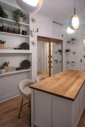 a kitchen with a island with a wooden counter top at Cozy Little Italy Retreat Steps from SoHo in New York
