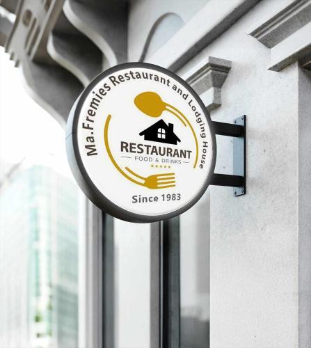 a sign for a restaurant hanging on a window at Ma Fremie Hometel in Lal-lo