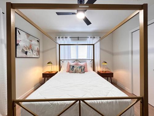 a bedroom with a canopy bed with two tables at Cozy Modern 3BR Escape - Sanford in Sanford