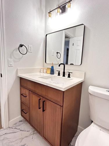 a bathroom with a sink and a mirror at Cozy Modern 3BR Escape - Sanford in Sanford