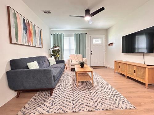 a living room with a couch and a flat screen tv at Cozy Modern 3BR Escape - Sanford in Sanford