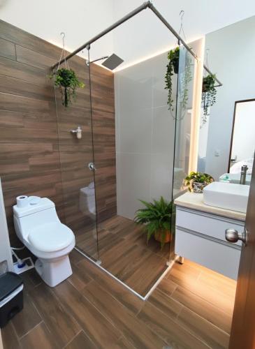 a bathroom with a shower and a toilet and a sink at Cerros de Anapoima in Anapoima