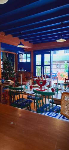 a dining room with tables and chairs and a christmas tree at Dar Wafa Riad, Restaurant and Hamam in Bangkok