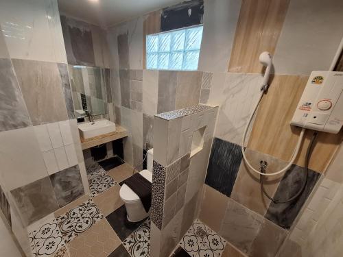 a bathroom with a shower and a toilet and a sink at So Good in Pai