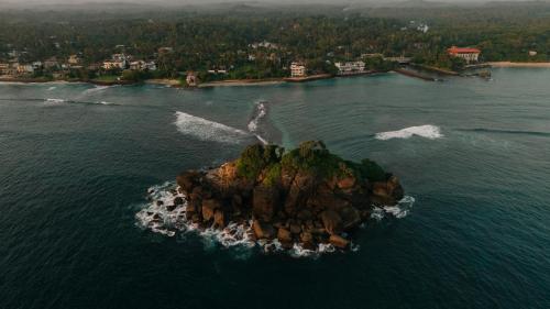 an island in the middle of the water at Beach House Goviyapana in Ahangama