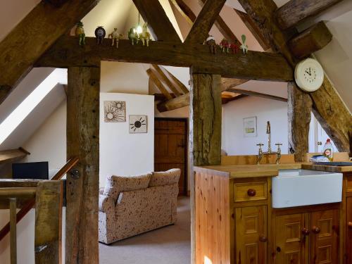 a kitchen with wooden beams and a counter with a sink at Lees Farm Apartment in Walcot