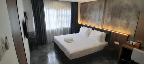 Postel nebo postele na pokoji v ubytování Muari Boutique Hotel