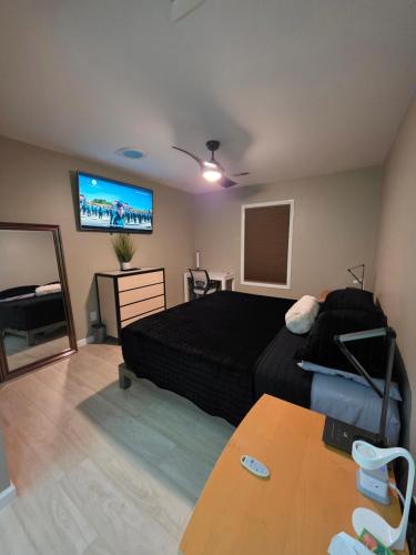 a bedroom with a bed and a flat screen tv at Modern/Retro Condo in High Point