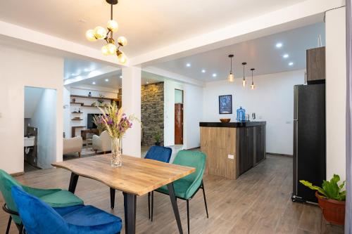 a dining room and living room with a table and chairs at Rural Retreat with Charming Patio 2 Bedrooms in Urubamba