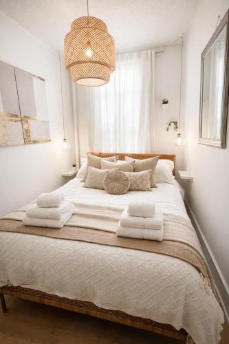 a bedroom with a large bed with towels on it at Cozy Little Italy Retreat Steps from SoHo in New York