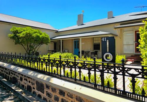 a house with a fence in front of it at Tanunda Central Cottage in Tanunda
