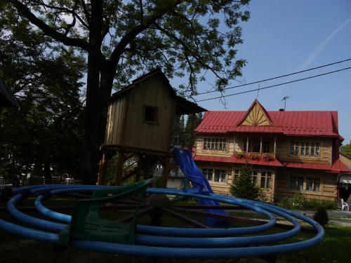 a group of water hoses in front of a house at Willa Pod Jesionem in Poronin