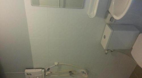 a bathroom with a toilet with a paper dispenser at A+ Hotel in Ban Na Khwai