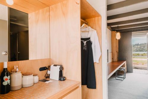 a kitchen with wooden cabinets and a counter top at The Black Dolphin Motel in Merimbula