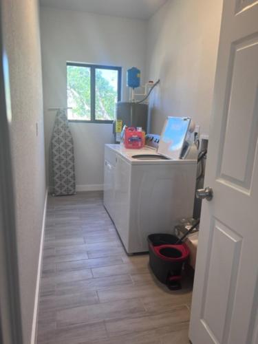 a room with a desk with a laptop computer on it at The Chill Crib in Fort Lauderdale