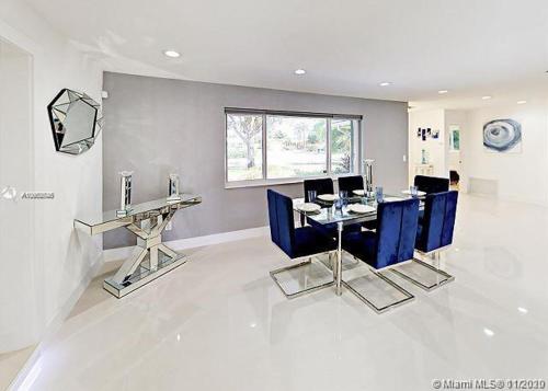 a dining room with blue chairs and a table at The Chill Crib in Fort Lauderdale