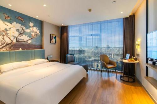 Postel nebo postele na pokoji v ubytování Magnotel Tongxiang Shimao Center