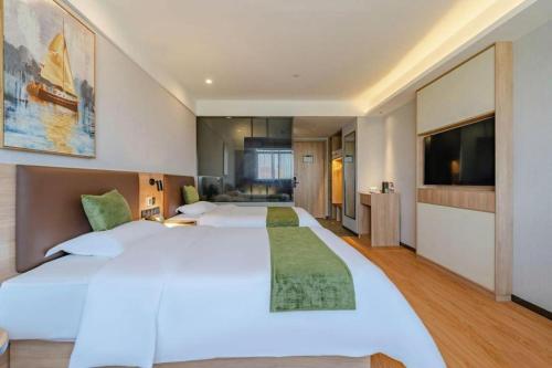 Giường trong phòng chung tại Green Tree Inn Anhui Suzhou Evergrande