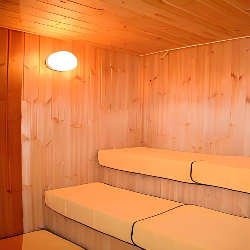 a room with two beds and a light on the wall at Hotel Capital in Yamagata in Yamagata