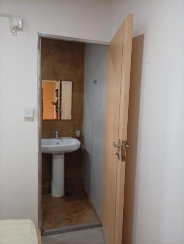 a bathroom with a sink and a mirror at Airport Transit Motel in Katunayaka