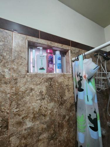 a bathroom with bottles of soap and toothbrushes at Casa Villafontana in Mexicali