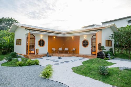 a house with a courtyard in front of it at Yugen House - Yutaka in Nong Prue