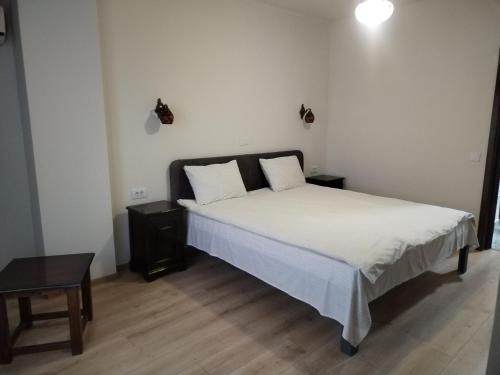 a bedroom with a large bed with white sheets at Hotel Majestic in Iaşi