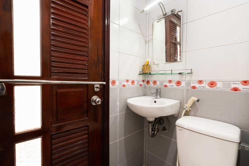 a bathroom with a toilet and a sink at Collection O Dinh Dinh Hotel - Near Tan Son Nhat Airport in Ho Chi Minh City
