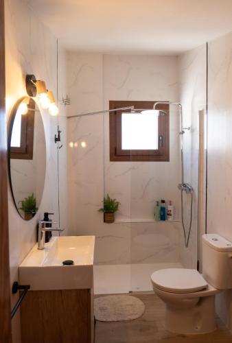 a bathroom with a toilet and a sink and a shower at La Terraza Guadalest in El Castell de Guadalest