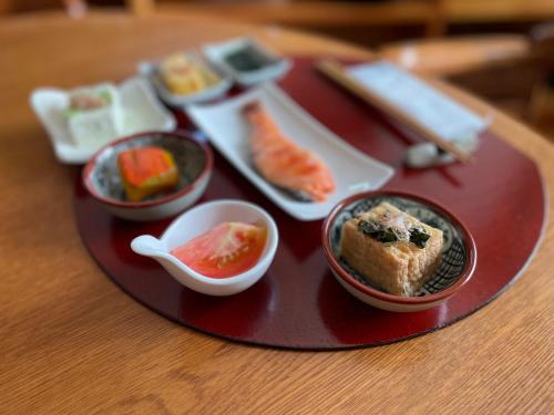 a plate with different types of food on a table at 暮らしや aizu Kurashiya aizu-One Group per Day 