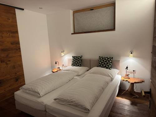 a bedroom with two beds and a mirror on the wall at Apartment Chalet Ambros in Lech am Arlberg