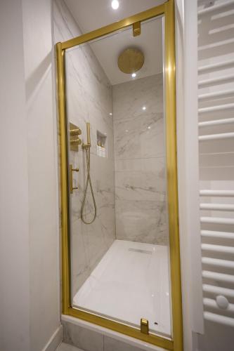 a shower with a glass door in a bathroom at The Sea Pearl in Eastbourne