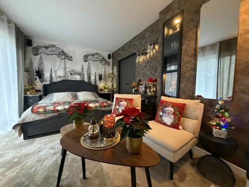 a bedroom with a bed and a table and a couch at Bienvenue chez Glad et Guigui in Rinxent