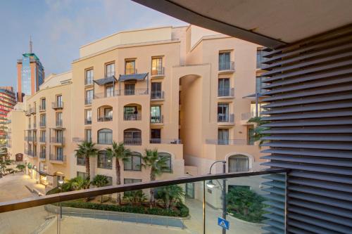 a view of a building from a balcony at Bright 1BR in the Heart of St Julians in St. Julianʼs