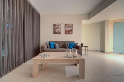 a living room with a couch and a coffee table at Bright 1BR in the Heart of St Julians in St. Julianʼs