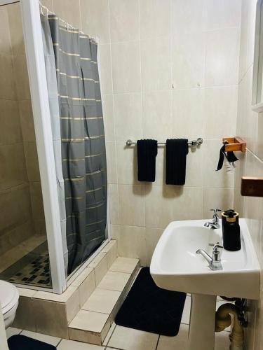 a bathroom with a sink and a shower at Kingsview, Margate in Margate