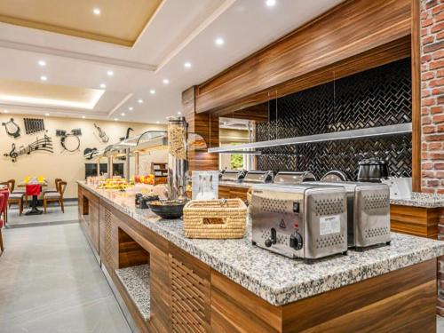 a kitchen with a counter with several appliances on it at Hotel Schwarzbachtal Hideaway in Erlbach