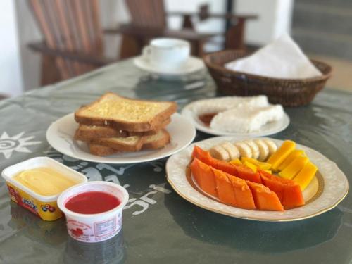 una mesa con tres platos de comida en una mesa en Sigiri Pandora Lodge & Hostel, en Sigiriya