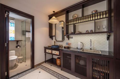 a bathroom with a sink and a toilet at Seahorse Tropical Da Nang Hotel by Haviland in Da Nang