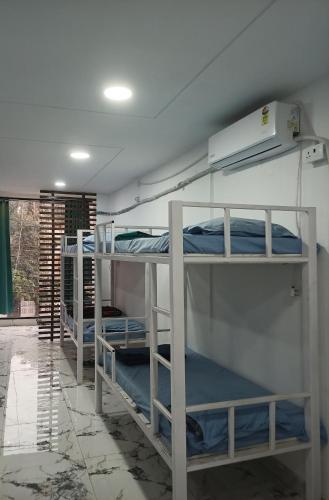 a room with three bunk beds in it at Leesha Tower - Dormitory in Jhānsi