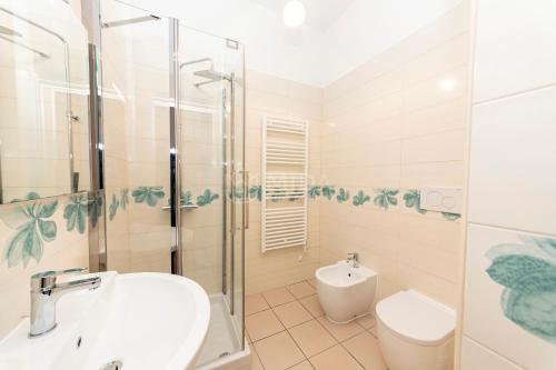 a bathroom with a shower and a sink and a toilet at Mama Bed in Porto Cesareo