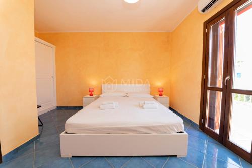 En eller flere senge i et værelse på Orange Sun - Chiusurelle Village