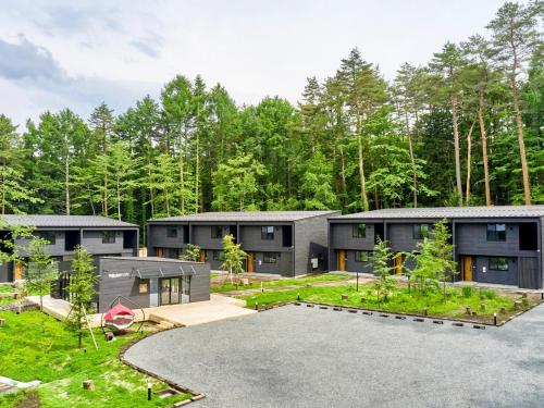 an exterior view of a house with a yard at Rakuten STAY VILLA Fuji Kawaguchiko Forest 2LDK with sauna and terrace in Fujikawaguchiko