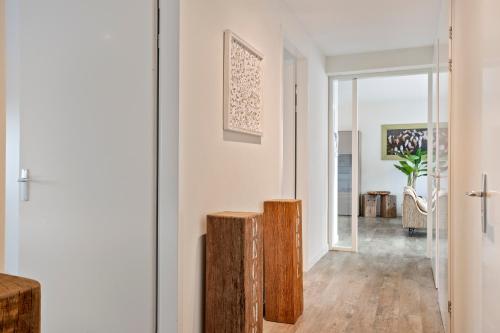 a living room with white walls and wooden floors at Vacation apartment Veerse Muze in Kamperland