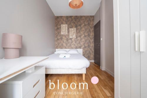 a white bedroom with a bed and a desk at Le Fabuleux de Deroulede in Nancy