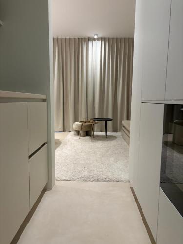 a living room with a table and a couch at Zilte Rust - luxe studio met private parking in Knokke-Heist