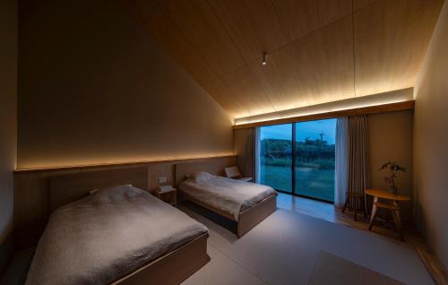 Postel nebo postele na pokoji v ubytování 2R Yakushima