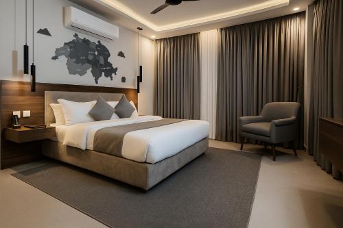 a hotel room with a bed and a chair at Alpirious in Islamabad