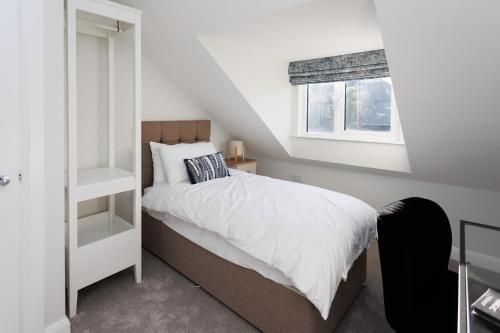 a small bedroom with a bed and a window at The Views Retreat in Newcastle