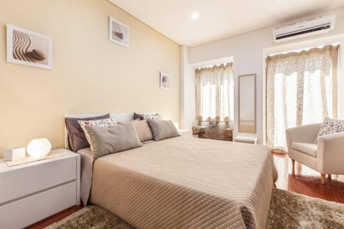 a bedroom with a large bed and a couch at Barnabe Apartment in Braga